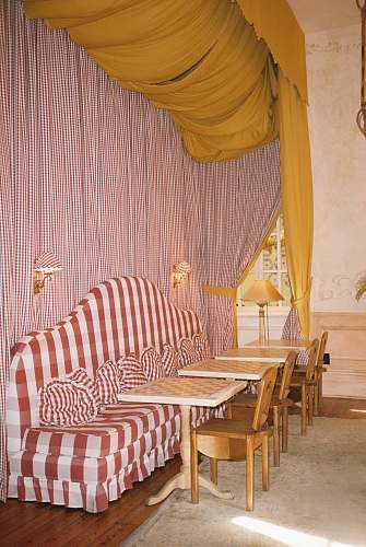 furniture white and orange couch near dining tables and chairs chair